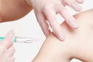 Human receiving a vaccination shot